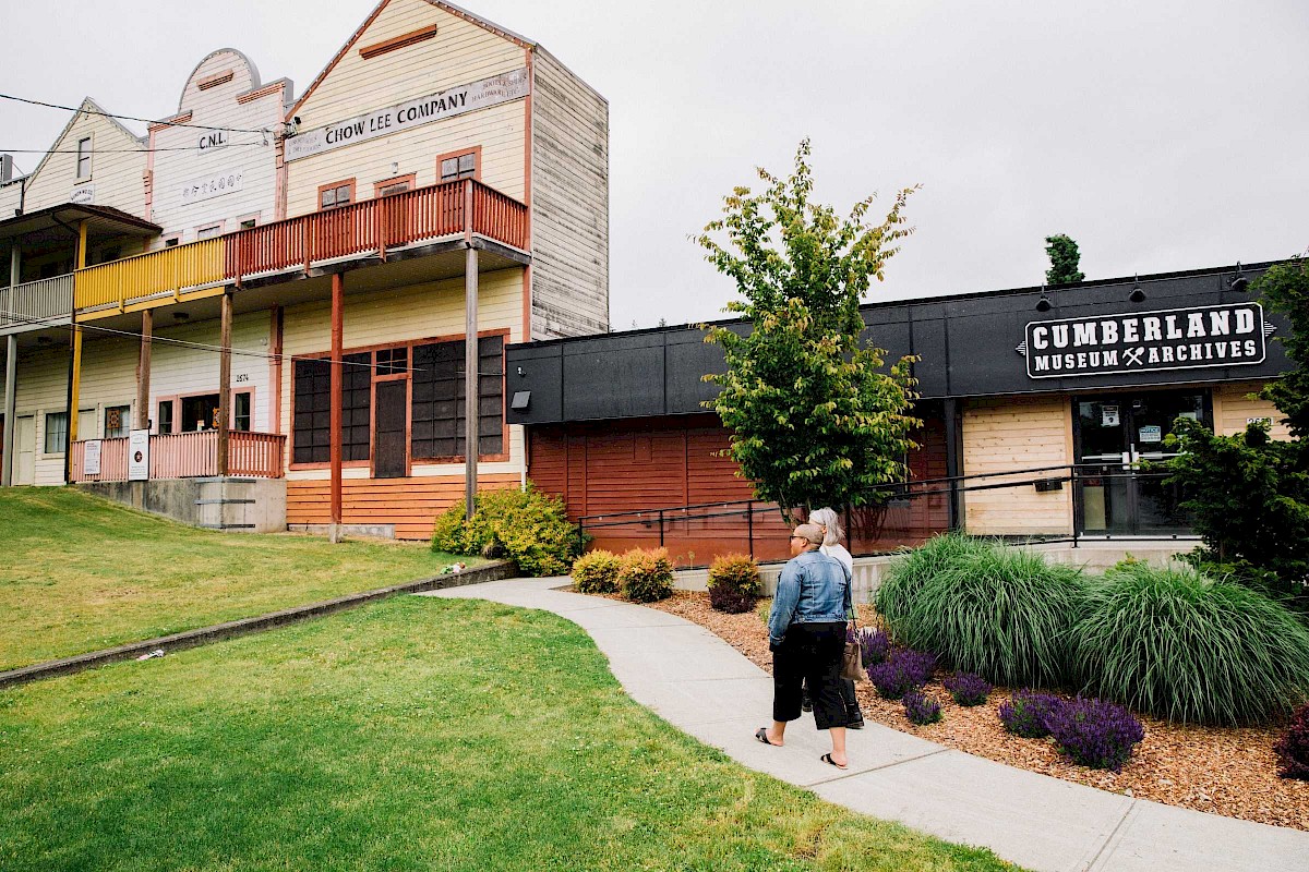 Two people walking towards the Cumberland Museum & Archives